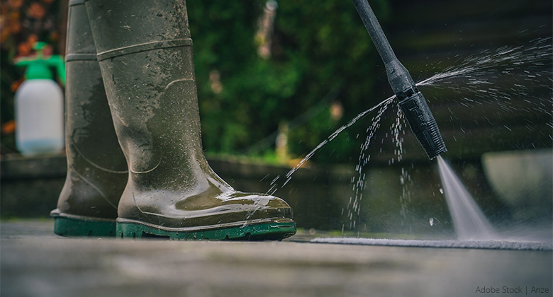 A calcified or dirty nozzle of a pressure washer leaks water at an unintended spot.