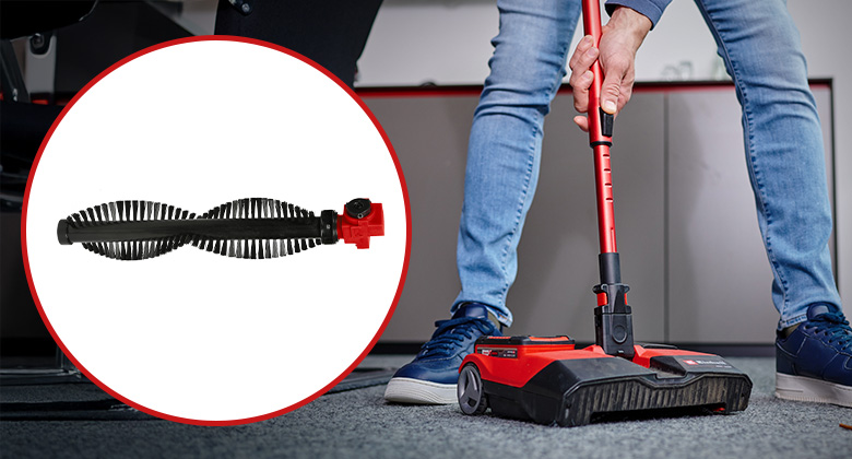 A person uses an Einhell cordless sweeper on a carpet; next to it is a replacement sweeping roller.