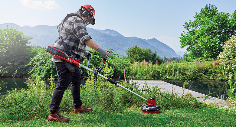 a man is working with a Einhell cordless scythes