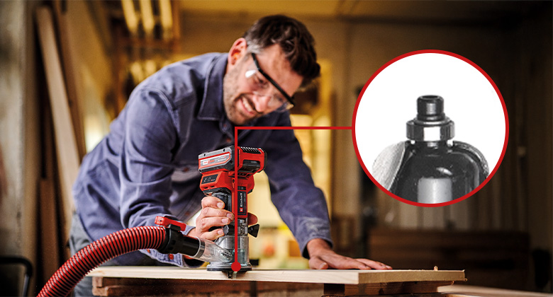 A man is using an Einhell cordless edge router on the edge of a wooden board, with a close-up showing the installed router bit with a guide ring.