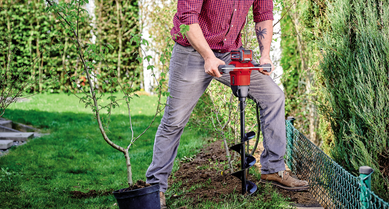 man working with cordless tiller