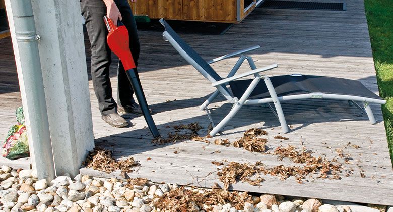 working with a leaf blower on a terrace