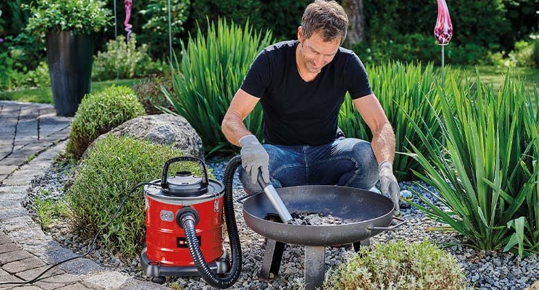 man using a cabled ash vacuum cleaner