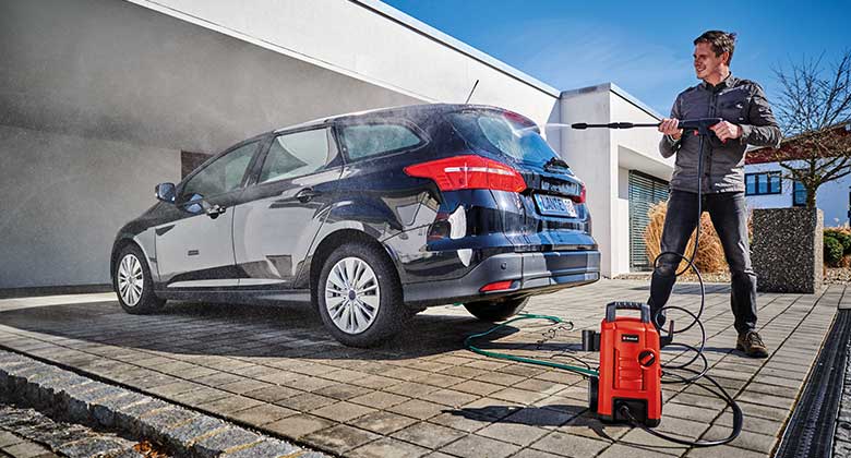 man washing a car with a high pressure cleaner from Einhell