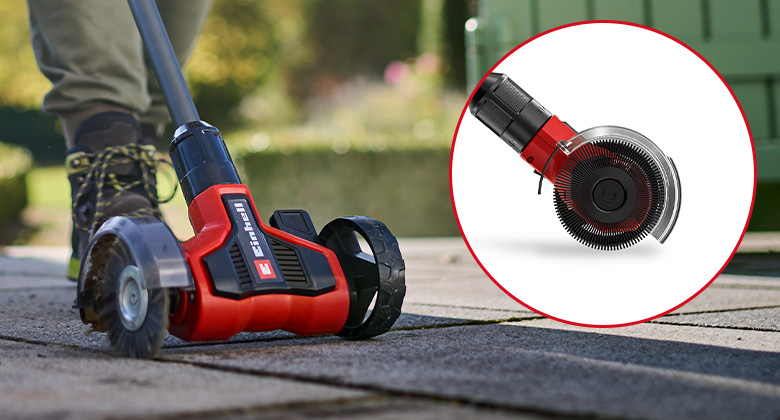 Close-up of the Einhell cordless patio cleaner with transparent guard over the rotating brush.