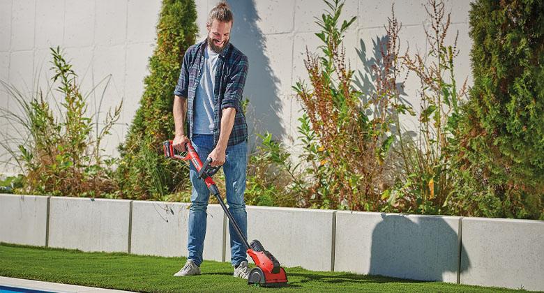 man using a cordless surface brush