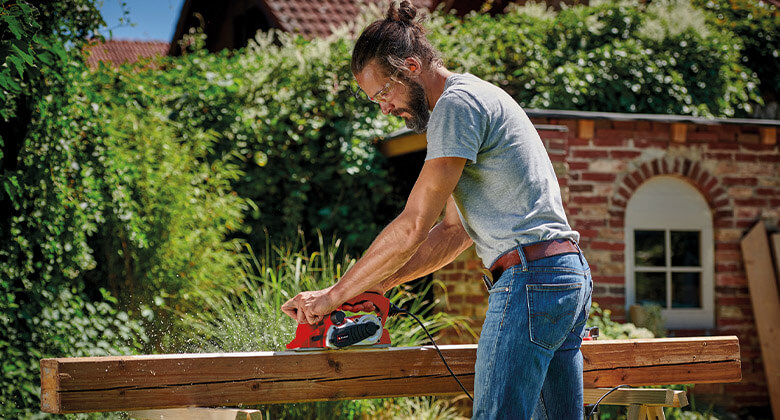 man using an electric planer
