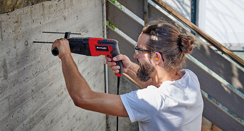 man using an electric rotary hammer