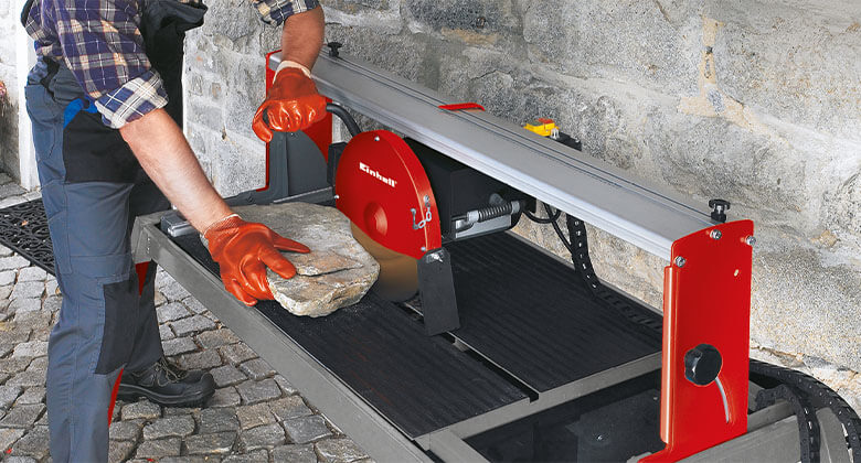 man cutting a stone with a stone cutting machine