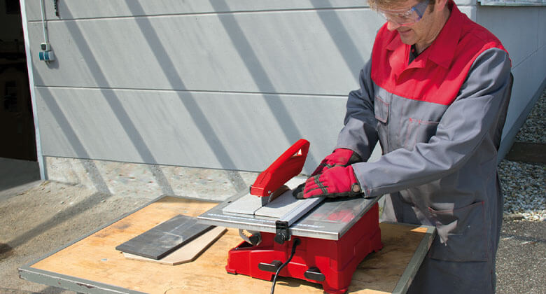 man working with a tile cutting machine
