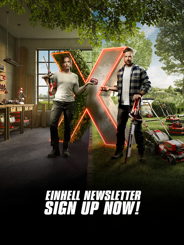Two people stand in a workshop and garden setting, holding power tools. A glowing X divides the spaces. Text reads, "Einhell Newsletter Sign Up Now!"